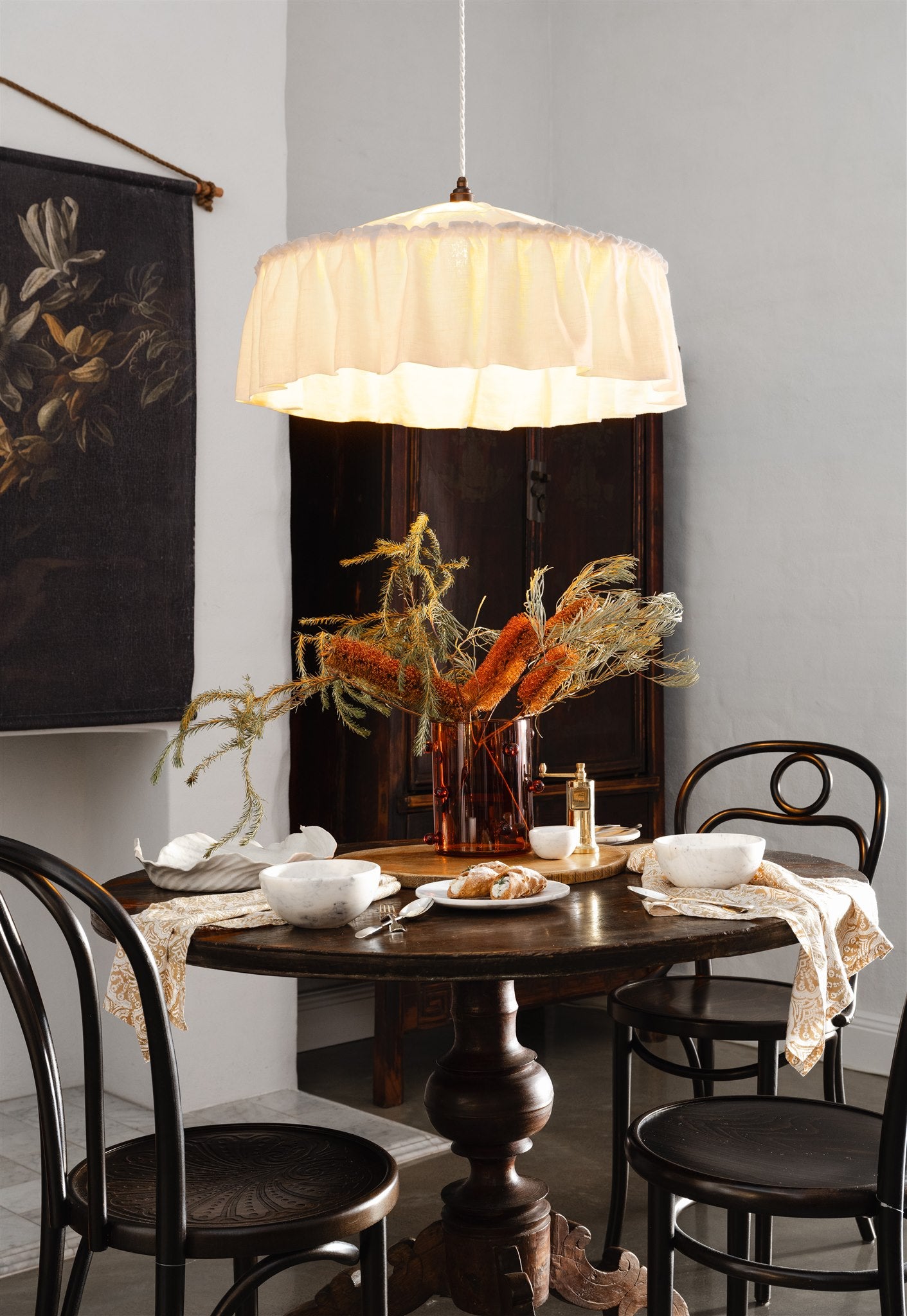 Dining room with a wooden table, chairs, and a pendant light.